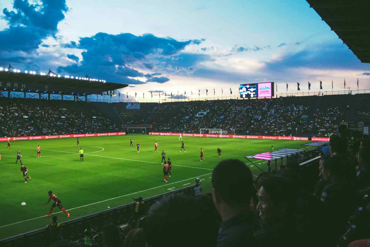 Uno stadio di calcio durante una partita al tramonto